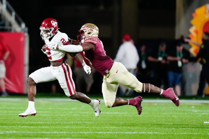 Florida State Seminoles defensive lineman Jared Verse (5) tackles Oklahoma Sooners running back Jovantae Barnes (2) during the 2022 Cheez-It Bowl. Mandatory Credit: Rich Storry-USA TODAY